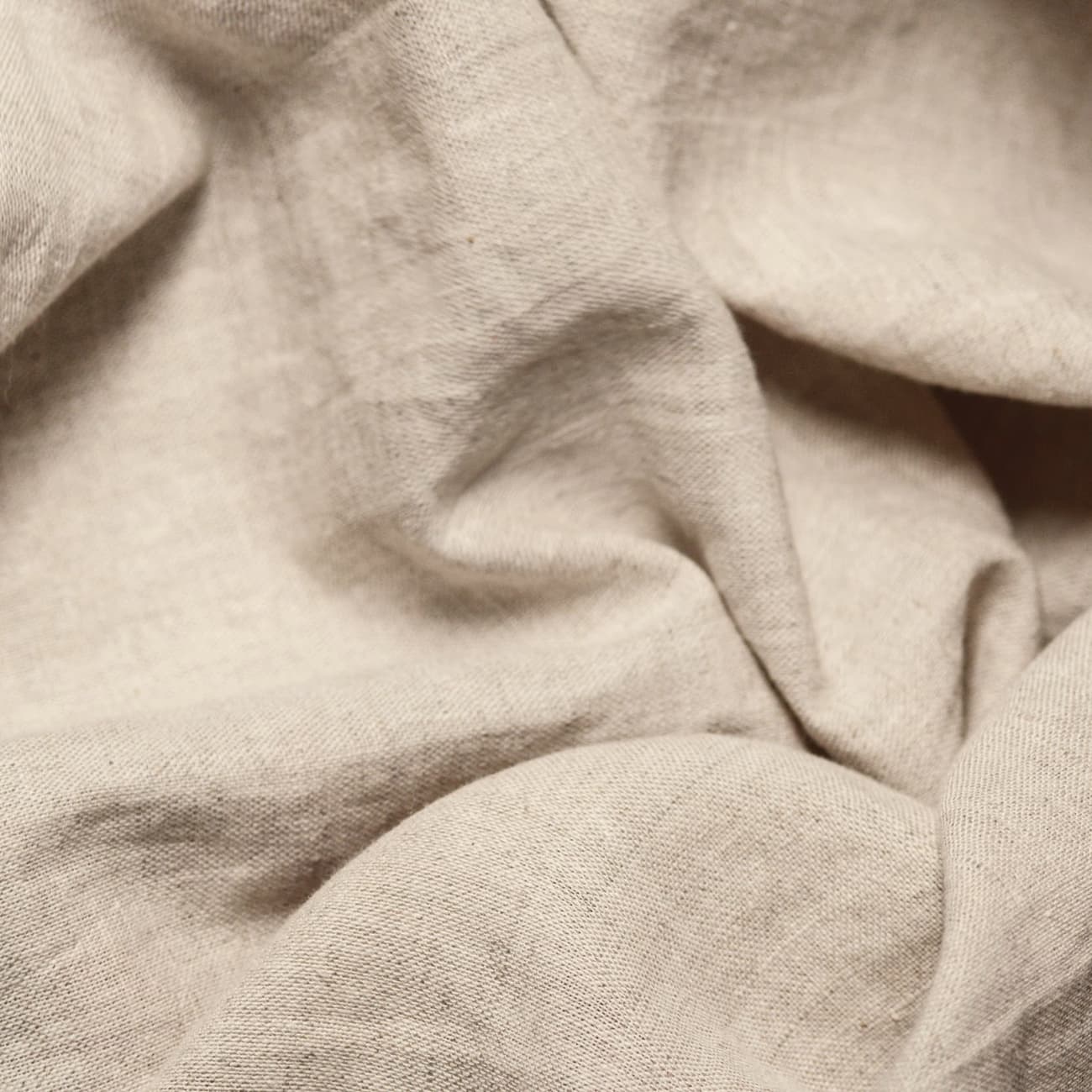 Folds of natural linen in raking light